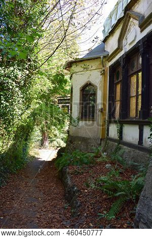 Andernach, Germany - 08 11 2022: Old Ruin At The Rheinsteig Trail With Long Gone Beer Brand Signs