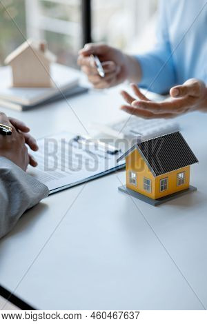Rental Company Employee Is Discussing The Details Before The Customer Agrees To Sign A Rental Contra