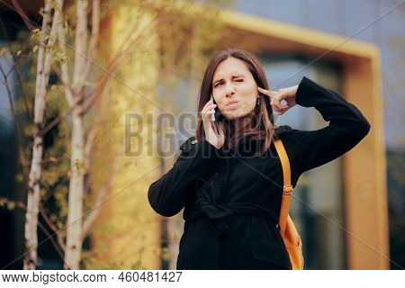 Woman Trying To Have A Phone Conversation In A Noisy City