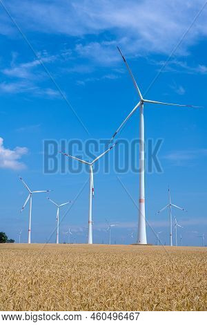 Wind Energy Plants In A Grainfield Seen In Germany