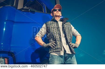 Proud Caucasian Semi Truck Driver In His 40s In Front Of His Modern Vehicle. Heavy Duty Transportati