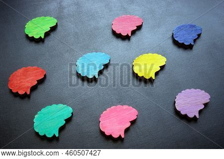 Neurodiversity Concept. Multi-colored Figures Of The Brain On A Dark Surface.
