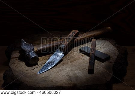Old Hammer And Old Knife. Vintage Tools. Still Life Of Tools. Knife And Whetstones. Beam Of Light In