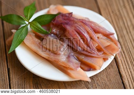 Pickled Squid On White Plate, Raw Squid For Cooking Food On Wooden Background, Preserving Food Seafo