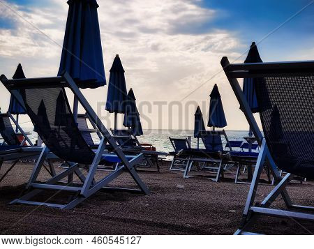 Umbrellas On The Beach In Late Summer On The Western Ligurian Riviera