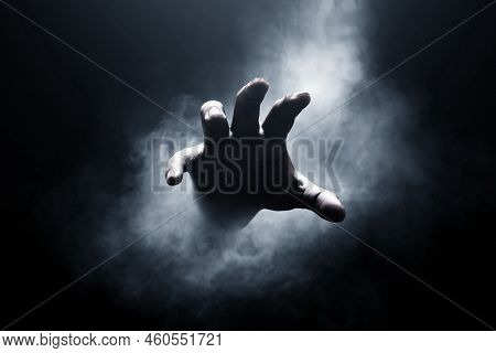 Human Hand Grab On Smoke Dark Background