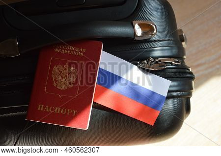 The Flag Of The Russian Federation And The Passport Of A Russian Citizen On A Black Suitcase For Tra