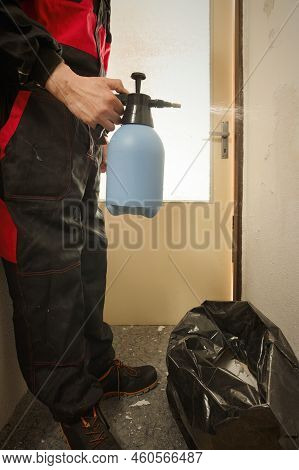 Older Man In Overall Moisturing Old Wallpapers In Apartment Room