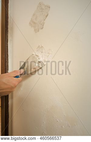 Detail Of Removing Old Wallpapers In Apartment Room