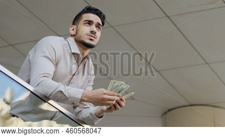 Bottom View Young Pensive Successful Bearded Guy Rich Business Man Holding Bundle Of Money Banknotes