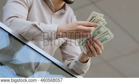 Close-up Of Male Hands Counting Dollar Bills Outdoors. Business Man Holding Count Money Cash In Offi