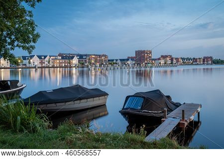 View Of The Modern Residential Neighbourhood And Waterfront Of Spaarndam At Dusk