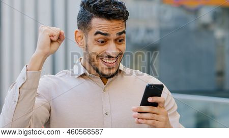 Hispanic Amazed Businessman Receiving Sms Message Offer Opportunity, Arabian Happy Man Reading Good 