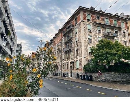 Geneva, Switzerland - September 15 2021: A Flower Pot Has Been Placed On The Sidewalk Along An Urban