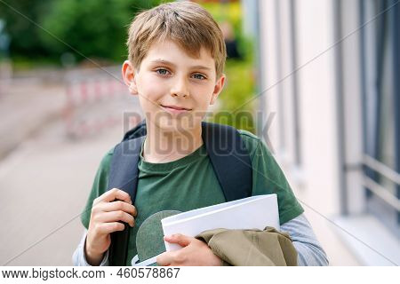 Happy Preteen Kid Boy With Backpack Or Satchel. Schoolkid In On The Way To Elementary Or Middle Scho
