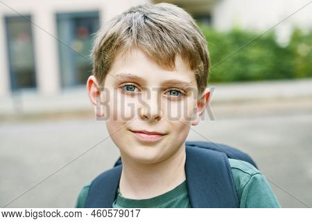 Happy Preteen Kid Boy With Backpack Or Satchel. Schoolkid In On The Way To Elementary Or Middle Scho