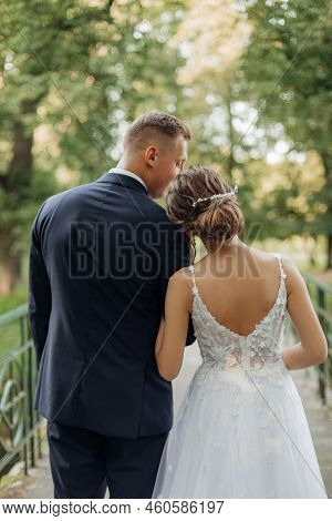 Rearview Of Vertical Cheerful, Chancy Young Married Couple Of Man And Woman Standing Together On Bri