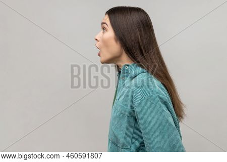Side View Of Astonished Woman With Widely Open Mouth In Amazement And Big Eyes Looking Ahead, Stunne