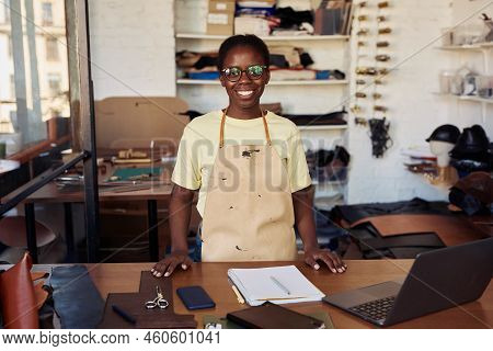 Portrait Of Female Small Business Owner Smiling At Camera While Posing In Leatherworking Workshop, C