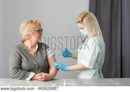 Senior Vaccination Concept. Elderly Getting Immune Vaccine At Arm For Flu Shot, Pneumonia, And Shing