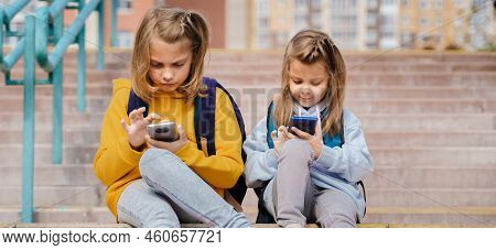Back To Elementary, Primary School. Little Girls With Backpack,mobile Phone. Surfing In Social Media