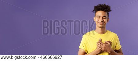 Always In My Heart. Touched, Carefree Handsome Young Man With Dreads, Yellow T-shirt, Close Eyes And