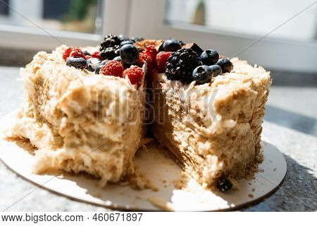 Savoyardi Berry Cake Garnished With Blackberries,blueberries And Fresh Figs On A Wooden Stand With H