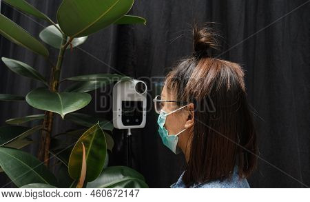 The Asian Tourist Woman Has Checked Body Temperature With A Thermal Temperature Scanner Detector, Ne