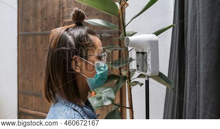 The Asian Tourist Woman Has Checked Body Temperature With A Thermal Temperature Scanner Detector, Ne