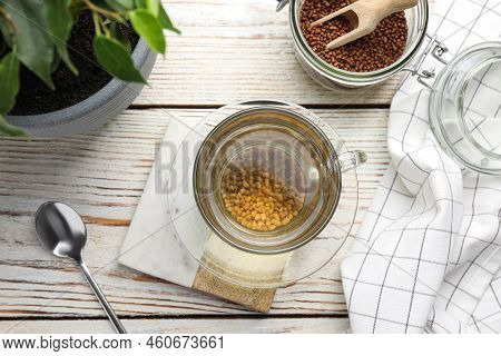 Freshly Made Buckwheat Tea On White Wooden Table, Flat Lay