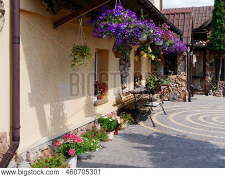 Brest, Belarus - August 18, 2022: Beautiful Stone House Decorated With Flowers And Greenery In Kamen