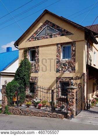 Brest, Belarus - August 18, 2022: Beautiful Stone House Decorated With Flowers And Greenery In Kamen