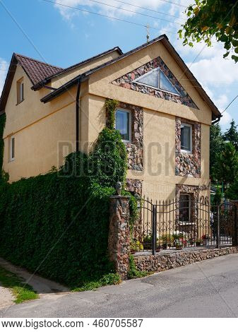 Brest, Belarus - August 18, 2022: Beautiful Stone House Decorated With Flowers And Greenery In Kamen