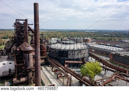 Ostrava, Czechia - September 23, 2020: Gong Gas Tank, Tall Chimney And Historical Buildings In Ostra