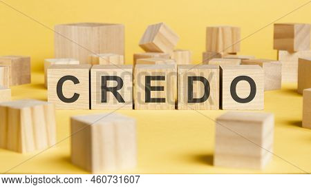 The Word Credo Written On Wooden Cubes On Yellow Background. Asset Management Or Financial Accountin