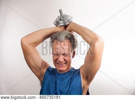 Mature Man 60plus Working Out With Weights At Home Doing Triceps Extensions