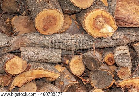 Natural Wooden Background - Close-up Of Chopped Firewood. Firewood Is Stacked And Prepared For Winte
