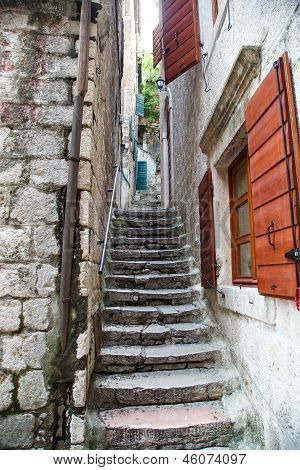 Stone Steps By Red Shutters
