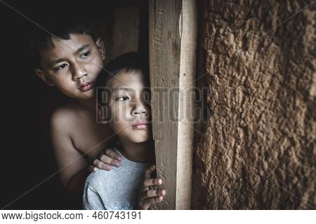 Two Poor Children Secretly Beside The Door, His Eyes Were Sad And Hopeless. The Concept Of Human Tra