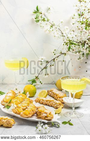 Limoncello. Traditional Italian Homemade Alcoholic Drink In Glass With Pieces Of Lemon, Sweet Italia