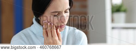 Woman Holding Her Cheek In Area Of Sore Tooth. Diagnosis And Treatment Of Pulpitis Concept