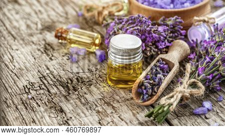 Lavender's Spa Products With Dried Lavender Flowers On A Wooden Table. Flat Lay Bath Salt And Massag