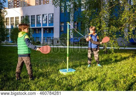 Two Friends Are Playing Tetherball Swing Ball Game In Summer Camping. Two Boy Brother Happy Leisure