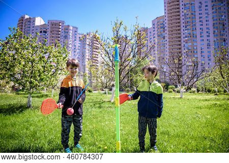 Two Friends Are Playing Tetherball Swing Ball Game In Summer Camping. Two Boy Brother Happy Leisure