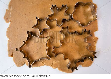 Cutting Out Cookies With Metal Mold From The Shortcrust Pastry. A Metal Forms In The Form Of Snowfla