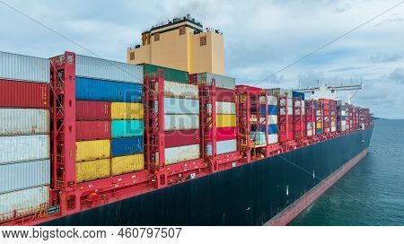 Side Viewof  Large Cargo Ship Import Export Container Box On The Ocean Sea On Blue Sky Back Ground C