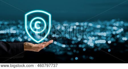 Copyright Or Patent Concept, Business Person Hand Holding Vr Screen Copyright Icon With Blue Bokeh B