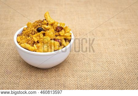 Spicy Chanachur In White Bowl Isolated On Burlap Fabric Background With Copy Space