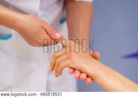 Facial Massage. A Woman Is Given A Massage In A Beauty Salon. Close-up.