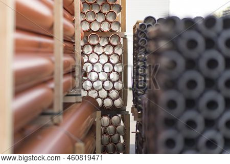 Background Of Orange Plastic Sewage Pipes Used At The Building Site. Texture And Pattern Of Plastic 